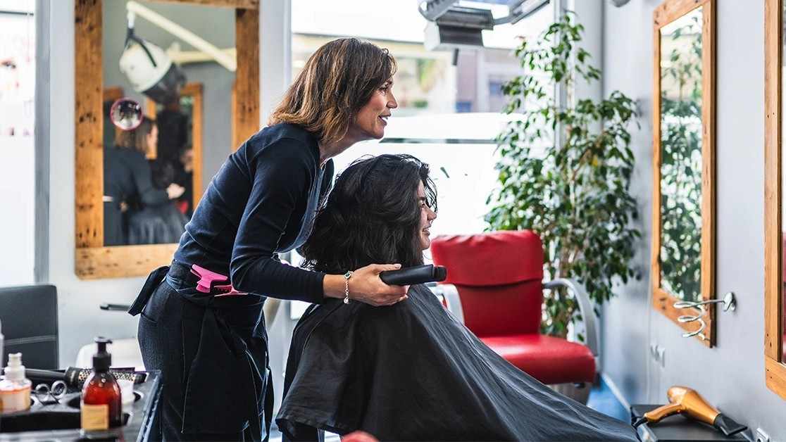 Luxurious salon with stylist assisting a happy customer during a hair treatment
