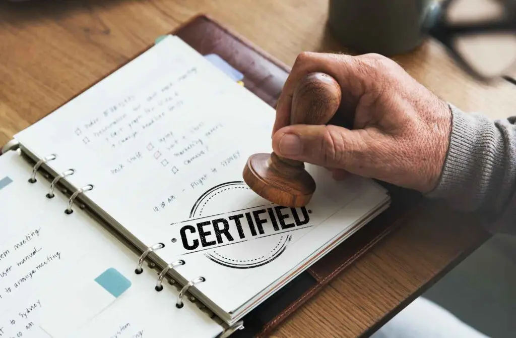 A person stamps a "certified" seal on a document.
https://www.freepik.com/free-photo/guarantee-approved-authorized-certified-concept_17433688.htm#fromView=search&page=1&position=16&uuid=cc5a800d-295c-4fc0-8907-5271784d86e2